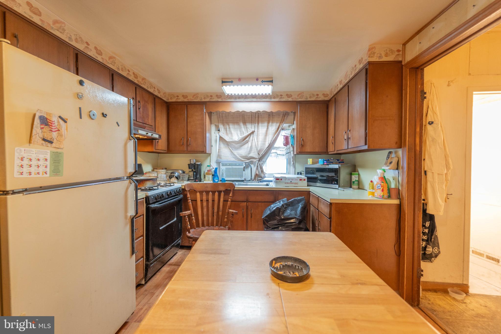 126 Olive Street Rancocas, NJ 08073 - Photo 5 of 12 a kitchen with refrigerator and cabinets