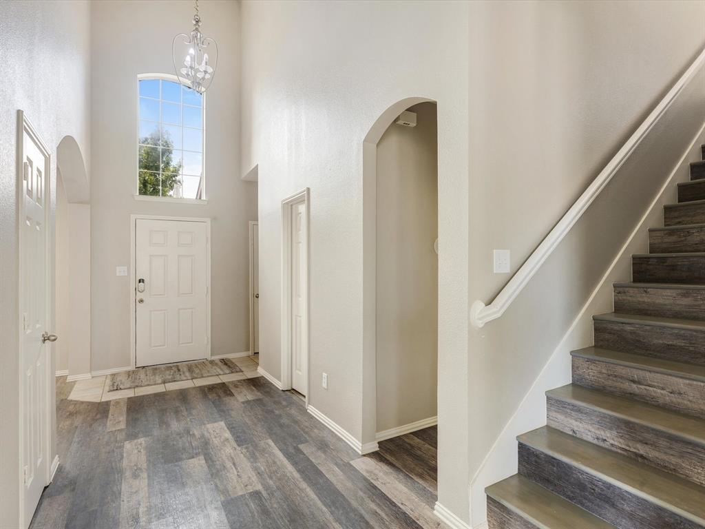 2009 Cooper Ridge Lane Heartland, TX 75126 - Photo 6 of 40 a view of a hallway with wooden floor and staircase