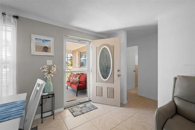 a living room with furniture a clock and a large window