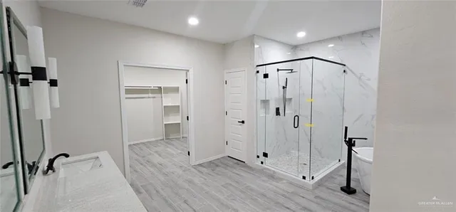 a bathroom with a shower a sink and a toilet