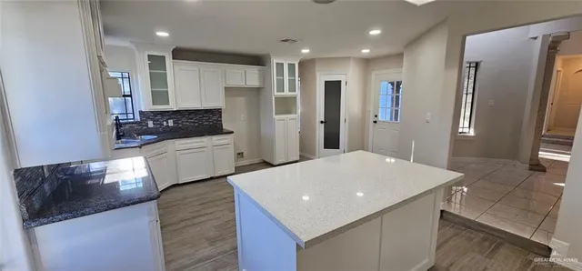 a kitchen with stainless steel appliances a refrigerator sink and stove