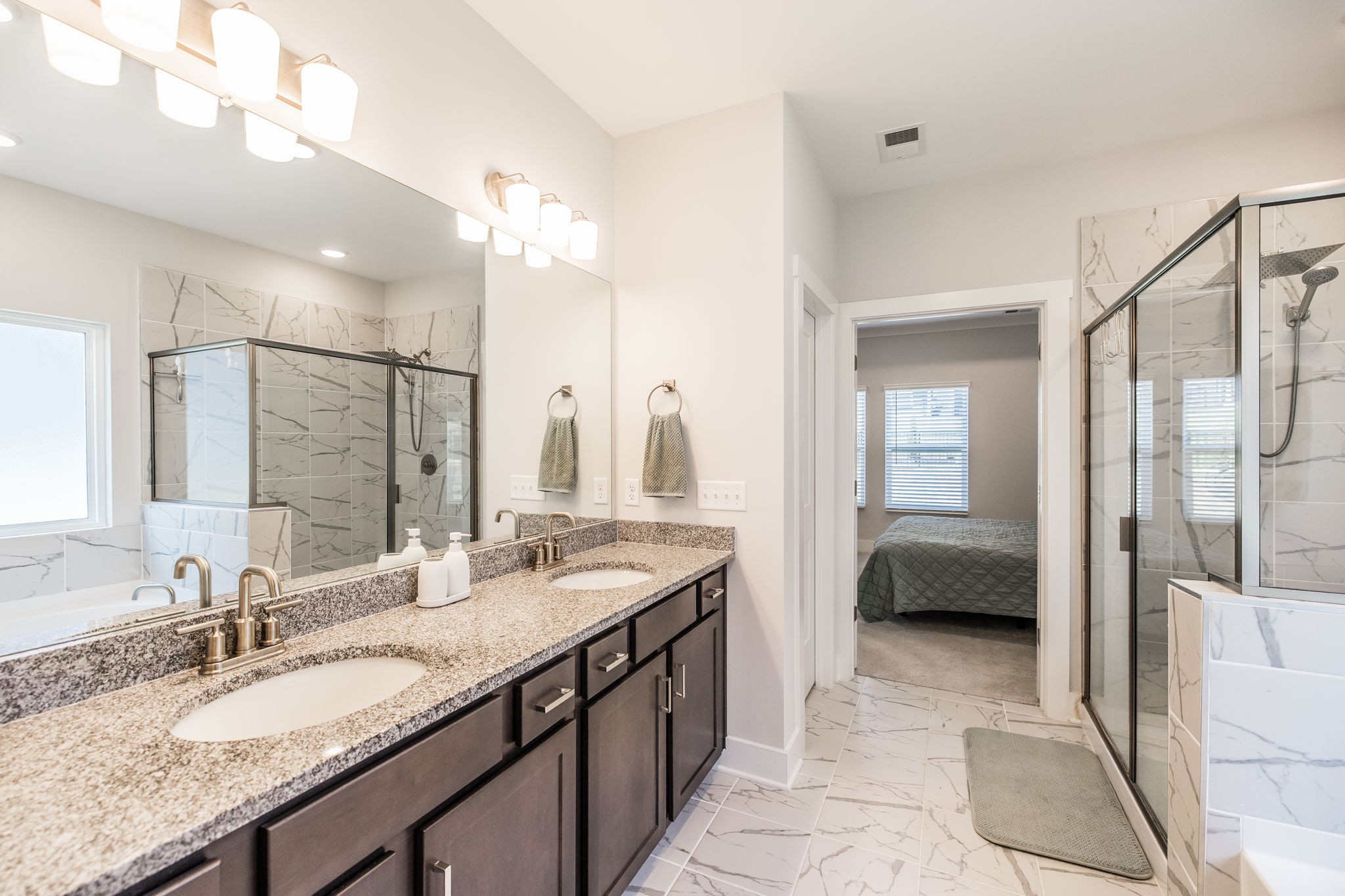 137 Cavalcade Loop Gallatin, TN 37066 - Photo 30 of 57 a en suite bathroom with a granite countertop sink a mirror and a shower
