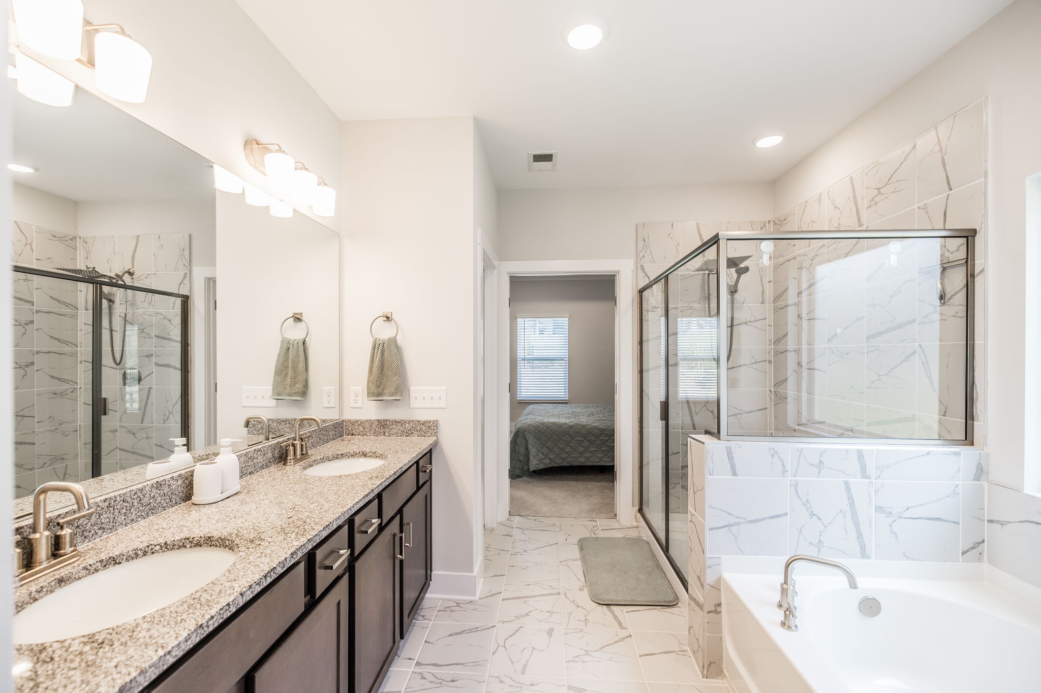 137 Cavalcade Loop Gallatin, TN 37066 - Photo 34 of 57 a spacious bathroom with a tub sink shower and mirror