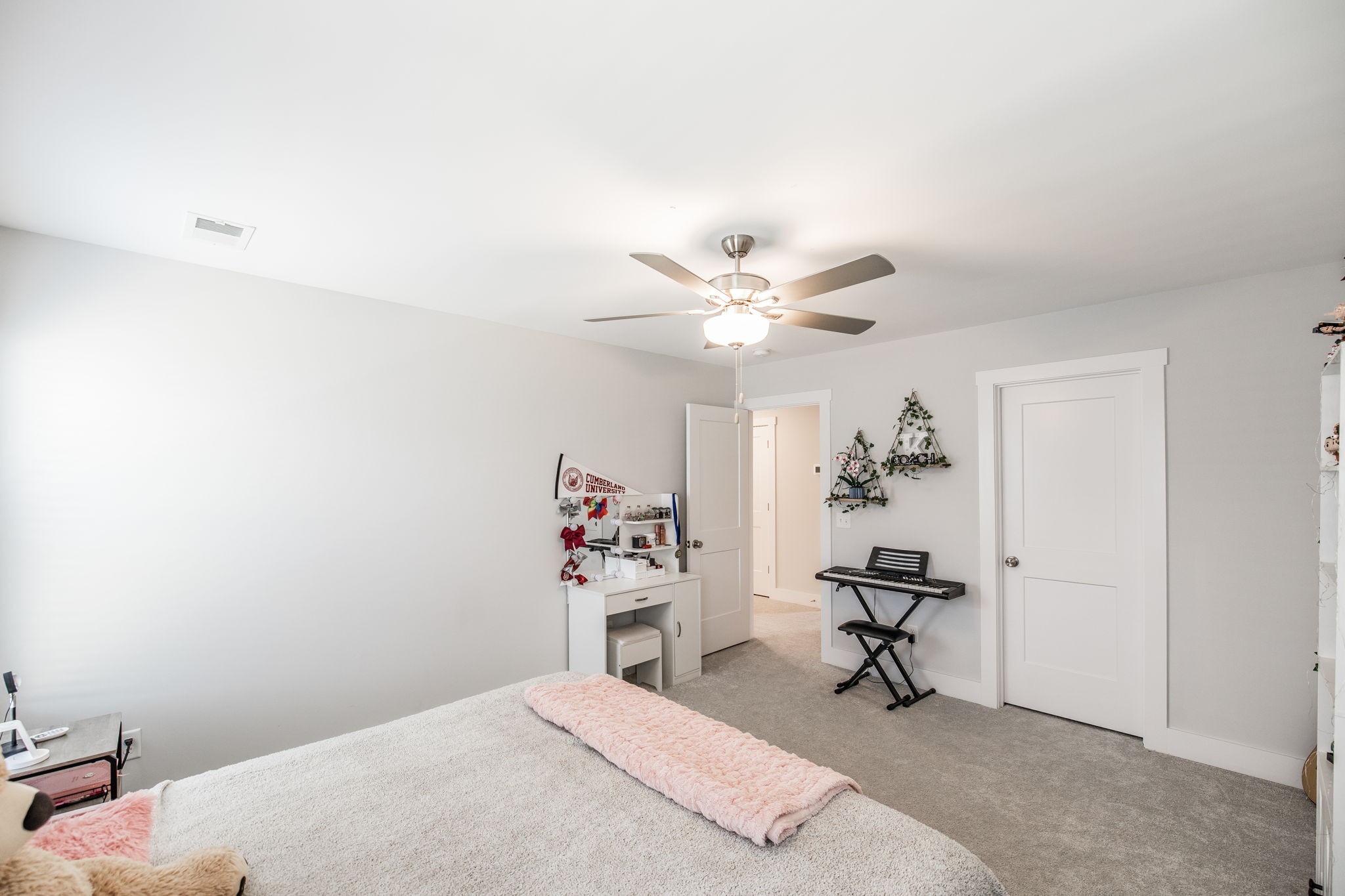 137 Cavalcade Loop Gallatin, TN 37066 - Photo 46 of 57 a bedroom with a bed and a chandelier fan