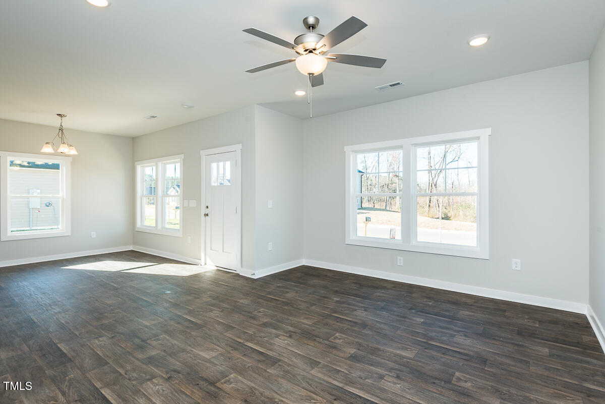 1030 Pinnix Loop Burlington, NC 27217 - Photo 24 of 25 a view of an empty room with window and wooden floor