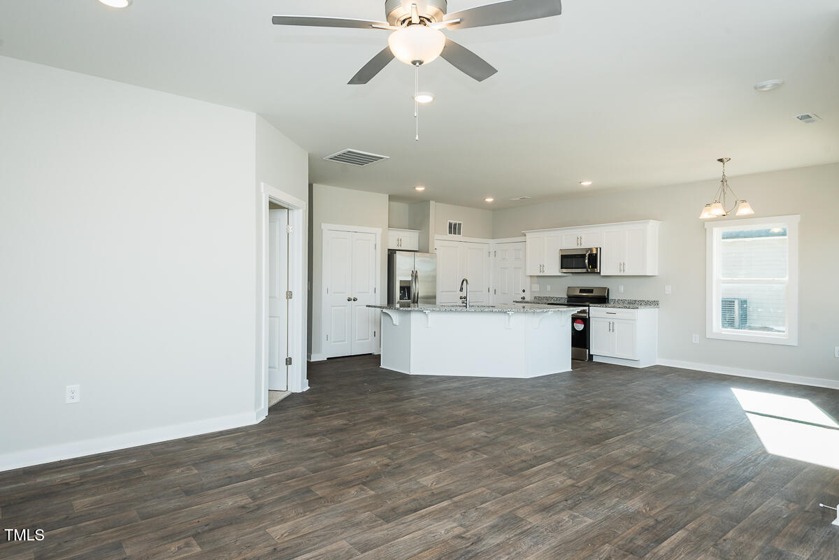 1030 Pinnix Loop Burlington, NC 27217 - Photo 25 of 25 a view of kitchen with kitchen island white cabinets and stainless steel appliances