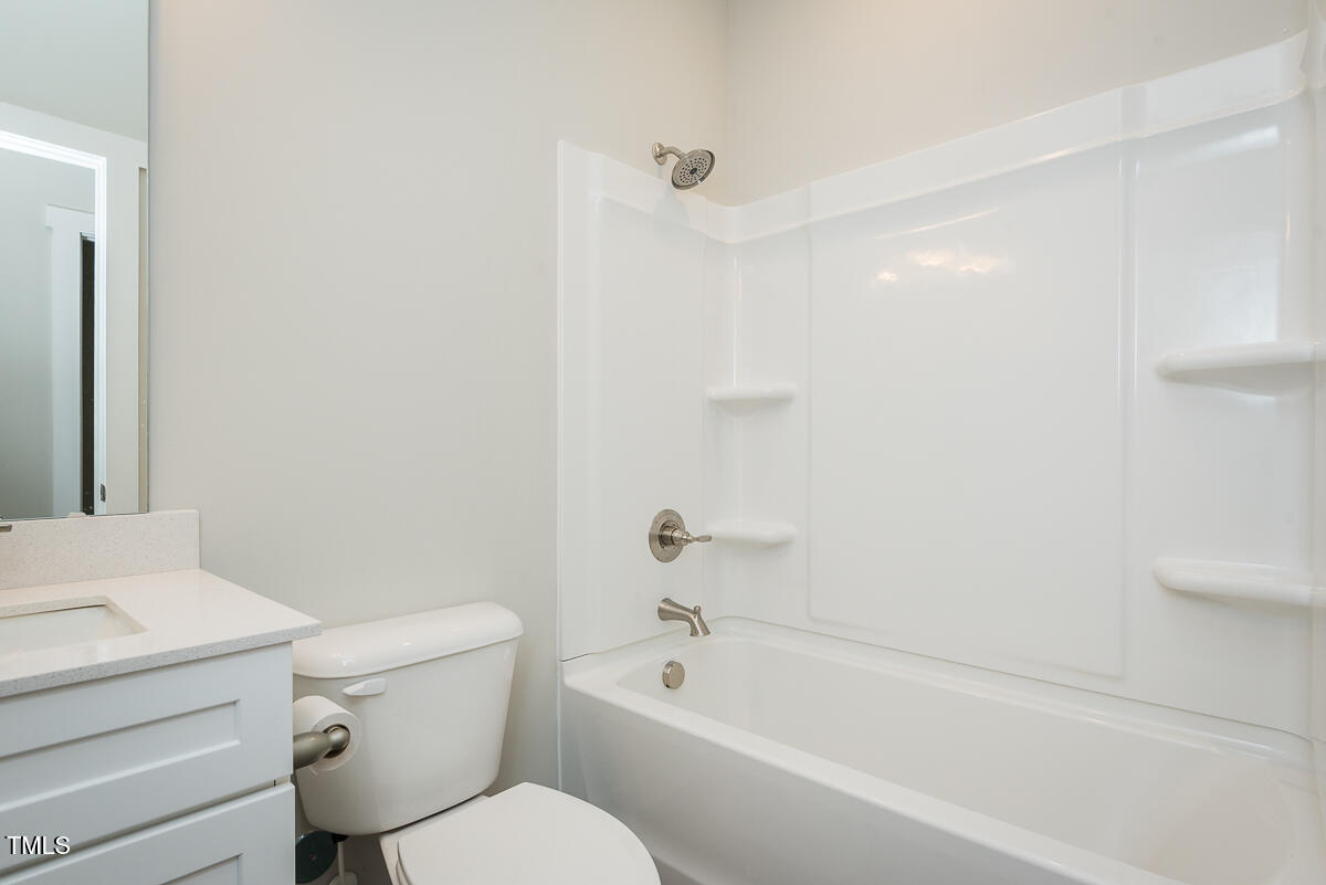 1030 Pinnix Loop Burlington, NC 27217 - Photo 18 of 25 a bathroom with a toilet and a bathtub