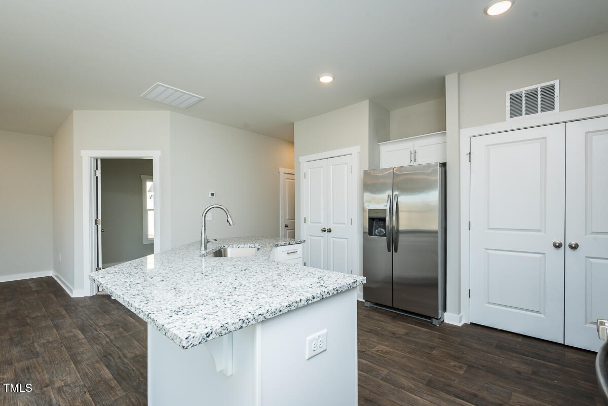 1030 Pinnix Loop Burlington, NC 27217 - Photo 8 of 25 a kitchen with kitchen island granite countertop a sink and refrigerator