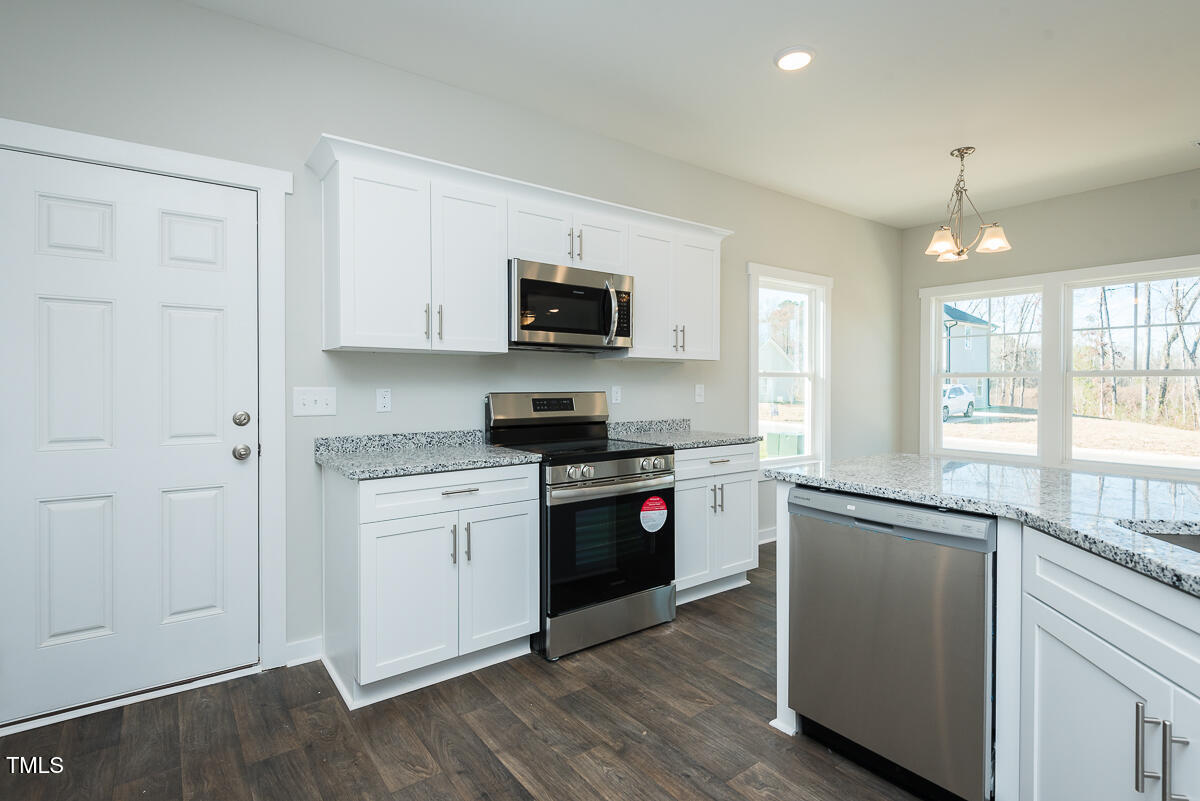 1030 Pinnix Loop Burlington, NC 27217 - Photo 10 of 25 a kitchen with stainless steel appliances granite countertop a stove and a refrigerator