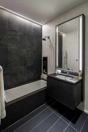a bathroom with a mirror a sink and shower