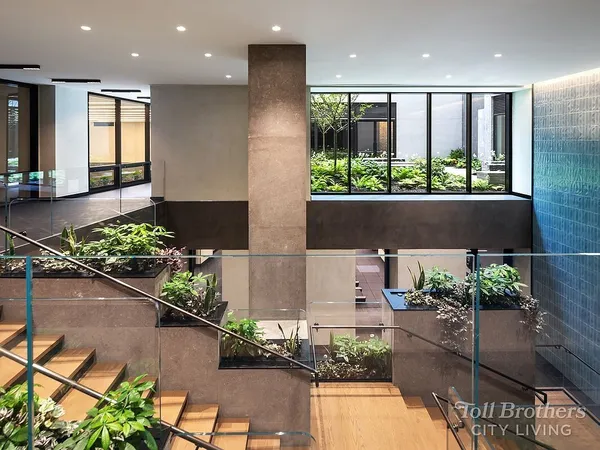 a living room with furniture and large windows