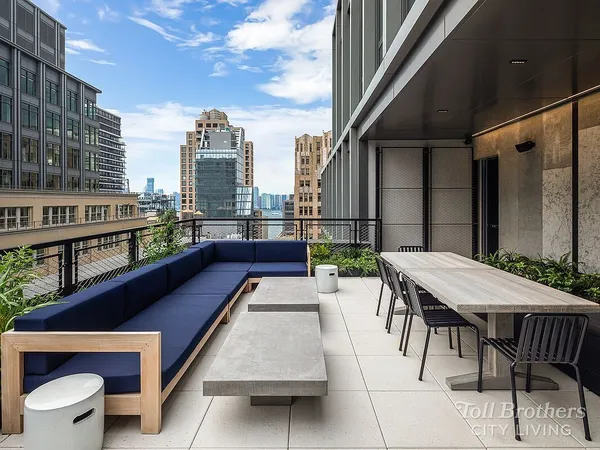 a kitchen with stainless steel appliances granite countertop a coffee maker and a table