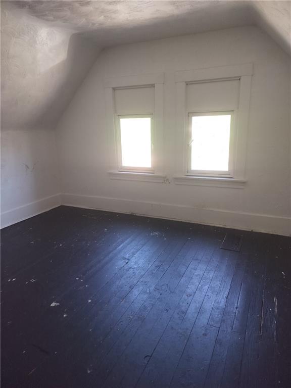 245 Fleet Street Braddock, PA 15104 - Photo 11 of 12 an empty room with wooden floor and windows