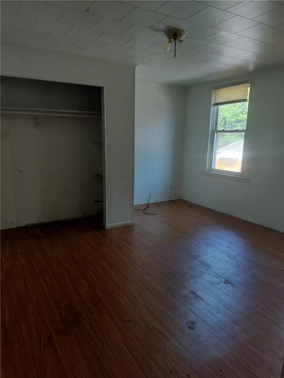 245 Fleet Street Braddock, PA 15104 - Photo 6 of 12 an empty room with wooden floor and windows