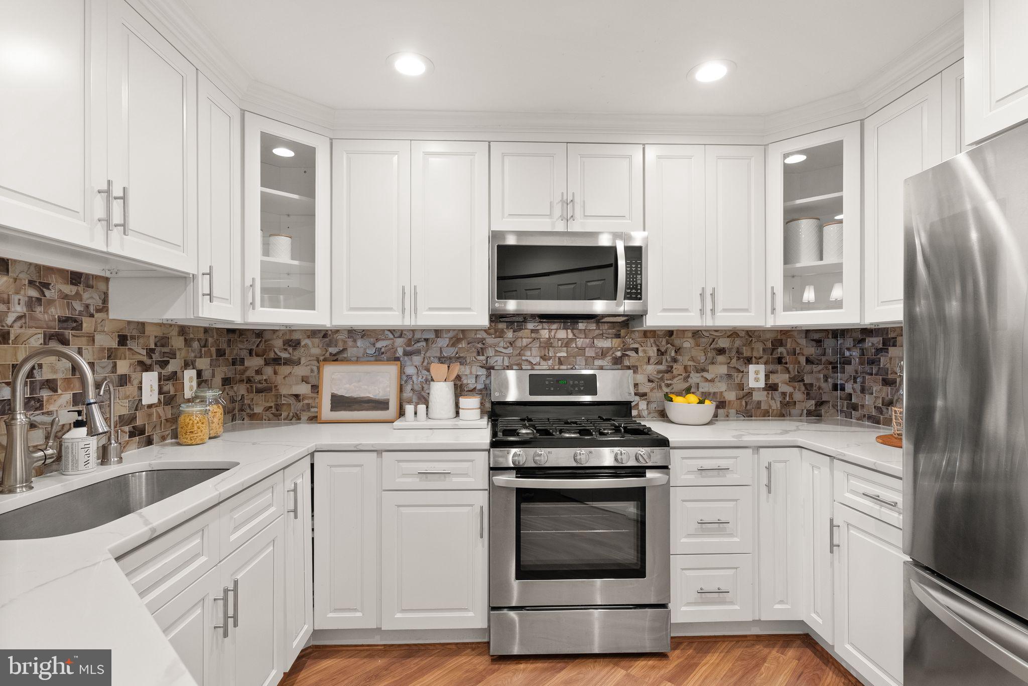 5565 Seminary Road, Unit 209 Falls Church, VA 22041 - Photo 4 of 34 a kitchen with stainless steel appliances white cabinets and sink