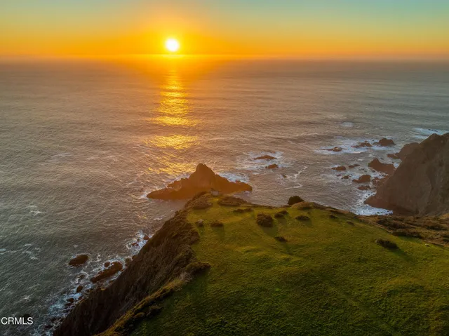 an aerial view of a house with a ocean view