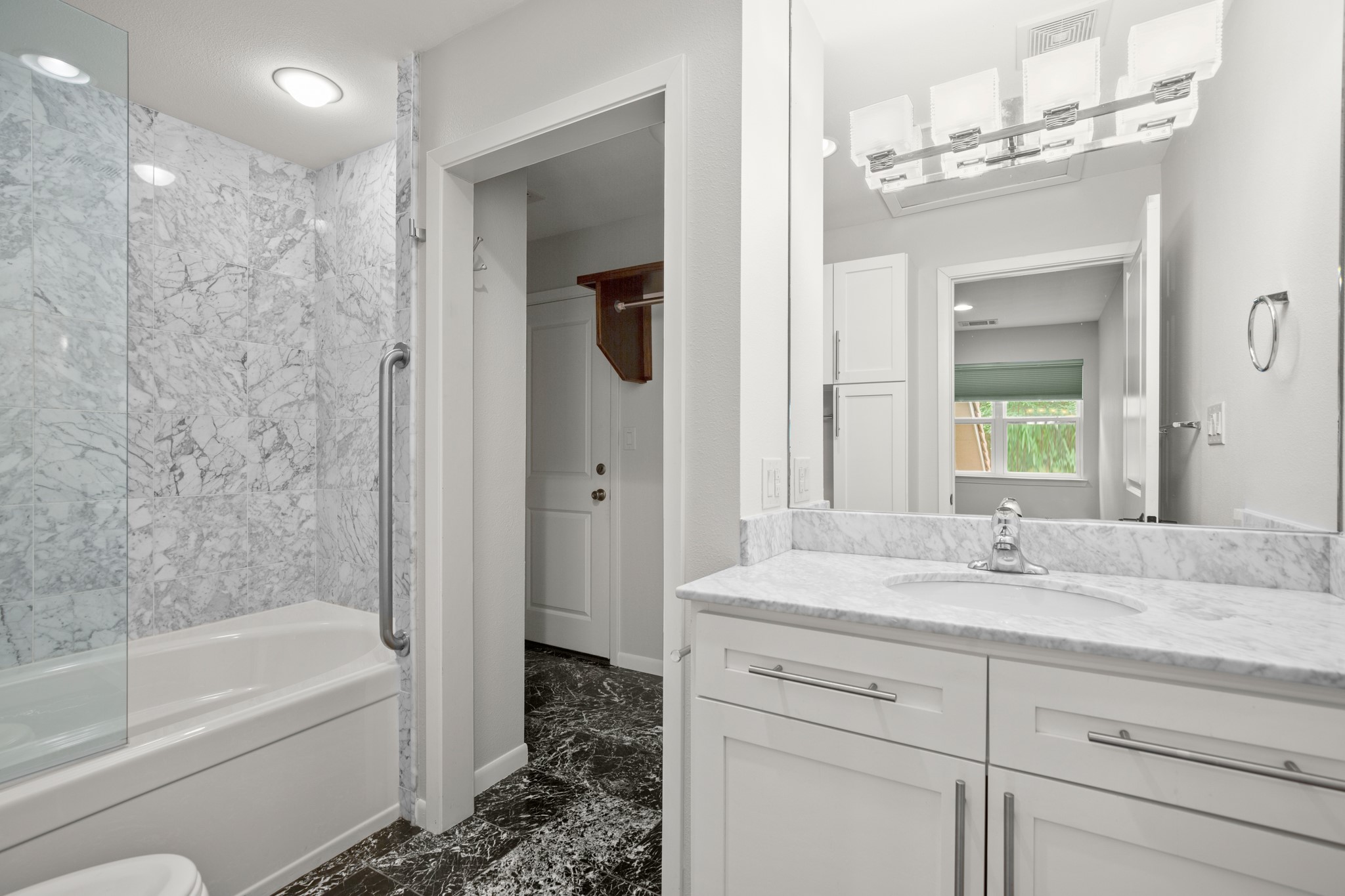 4116 Creek Ledge, Unit 108 Austin, TX 78731 - Photo 19 of 35 The second bedroom's private ensuite bath comes with a stylish contemporary vanity and a shower/tub combo with a frameless glass splash guard.