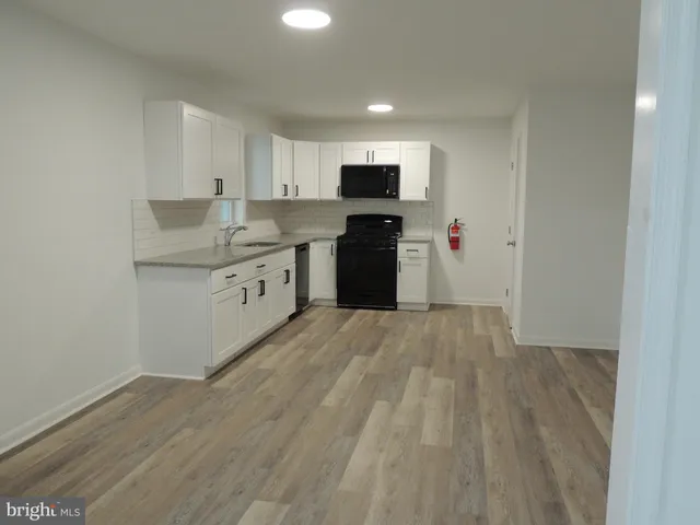 a kitchen with stainless steel appliances a refrigerator and a stove top oven