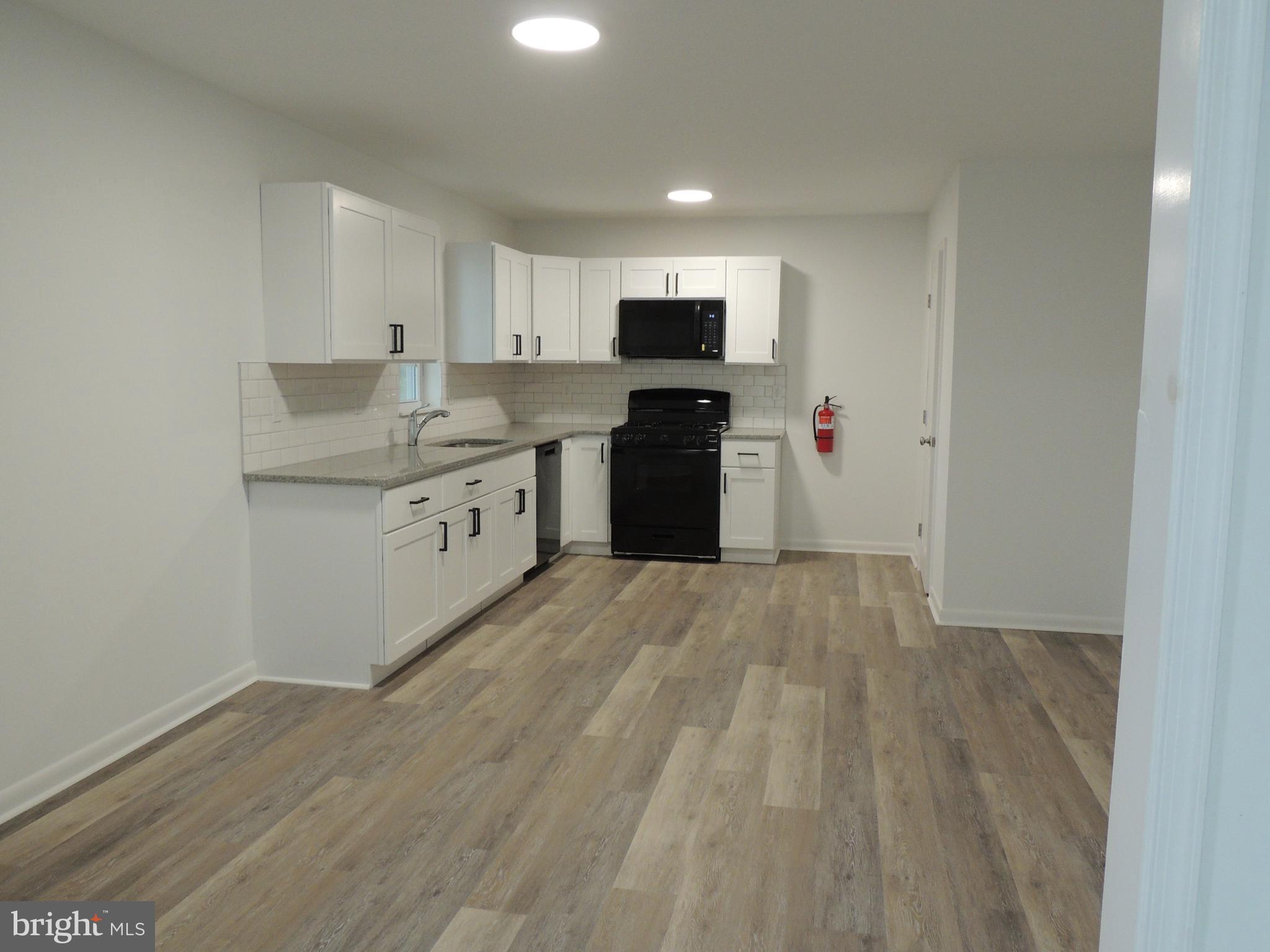 217 Broad Street Swedesboro, NJ 08085 - Photo 2 of 14 a kitchen with stainless steel appliances a refrigerator and a stove top oven