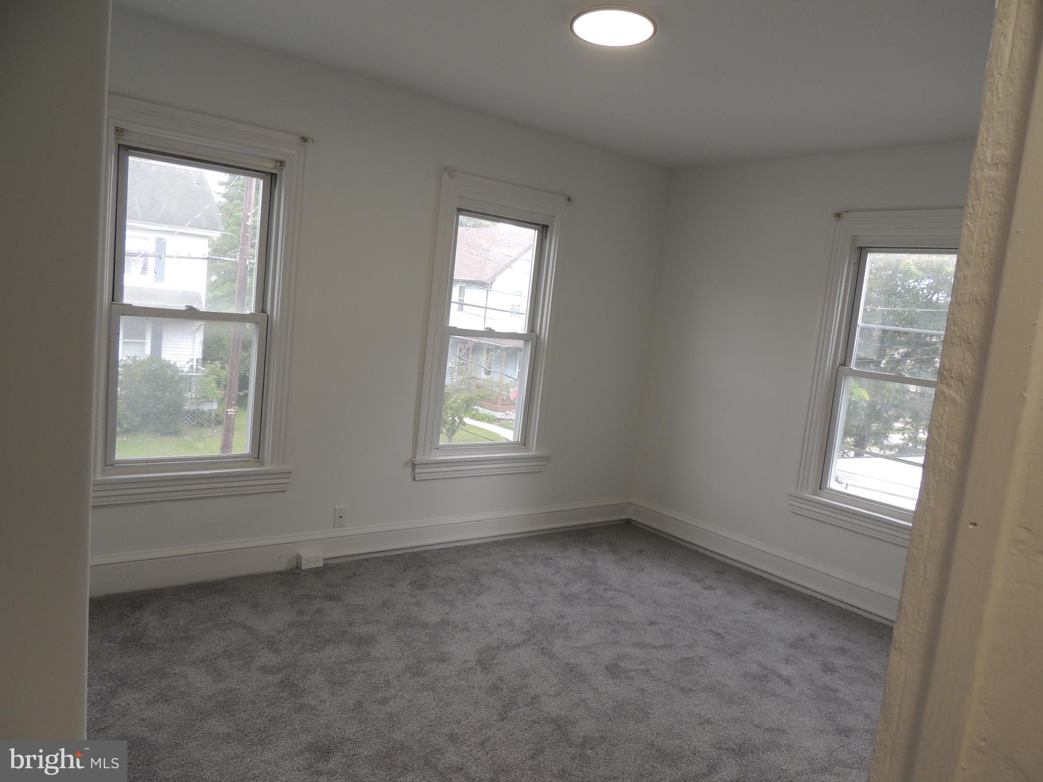 217 Broad Street Swedesboro, NJ 08085 - Photo 8 of 14 an empty room with windows