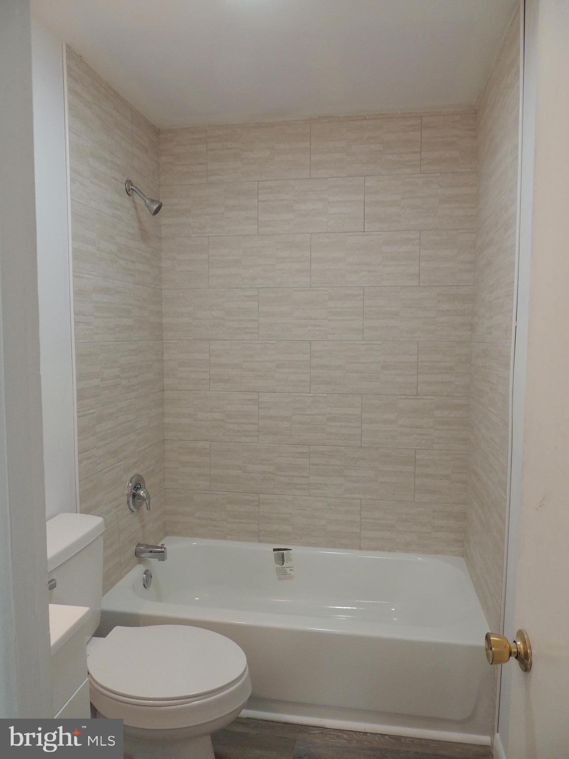 217 Broad Street Swedesboro, NJ 08085 - Photo 10 of 14 a bathroom with a toilet and a bathtub