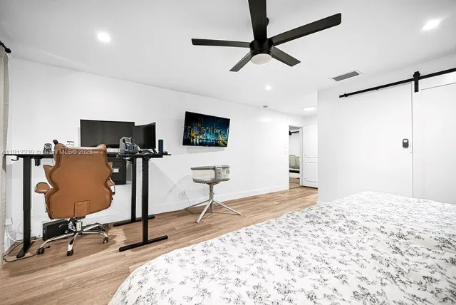 a view of a livingroom with workspace and a window