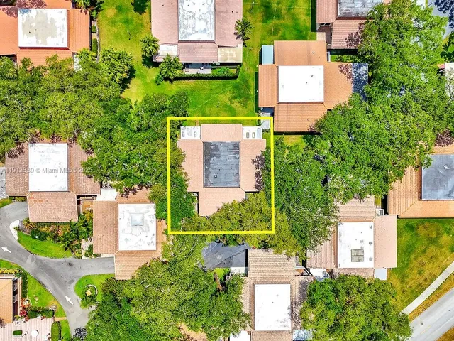 a view of backyard of house with green space