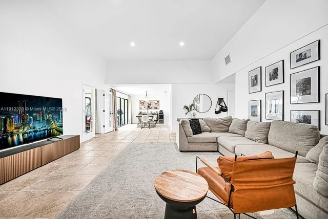 a living room with furniture a fireplace and a flat screen tv