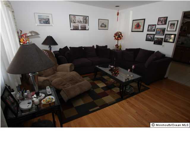 822 Beaver Dam Road Point Pleasant, NJ 08742 - Photo 2 of 3 a living room with furniture a rug and a lamp