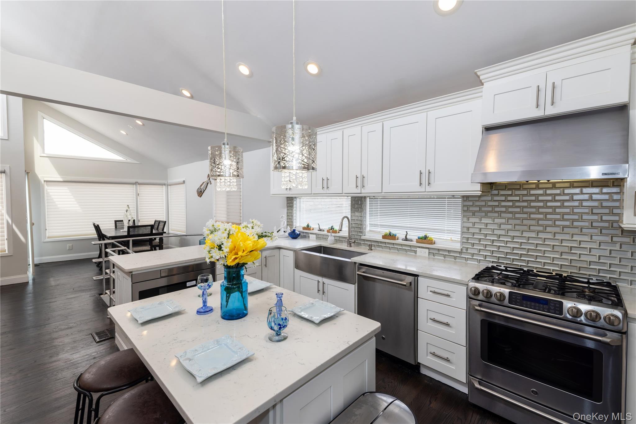 2590 Riverside Drive Wantagh, NY 11793 - Photo 5 of 27 Contemporary kitchen featuring white cabinetry and stainless-steel appliances