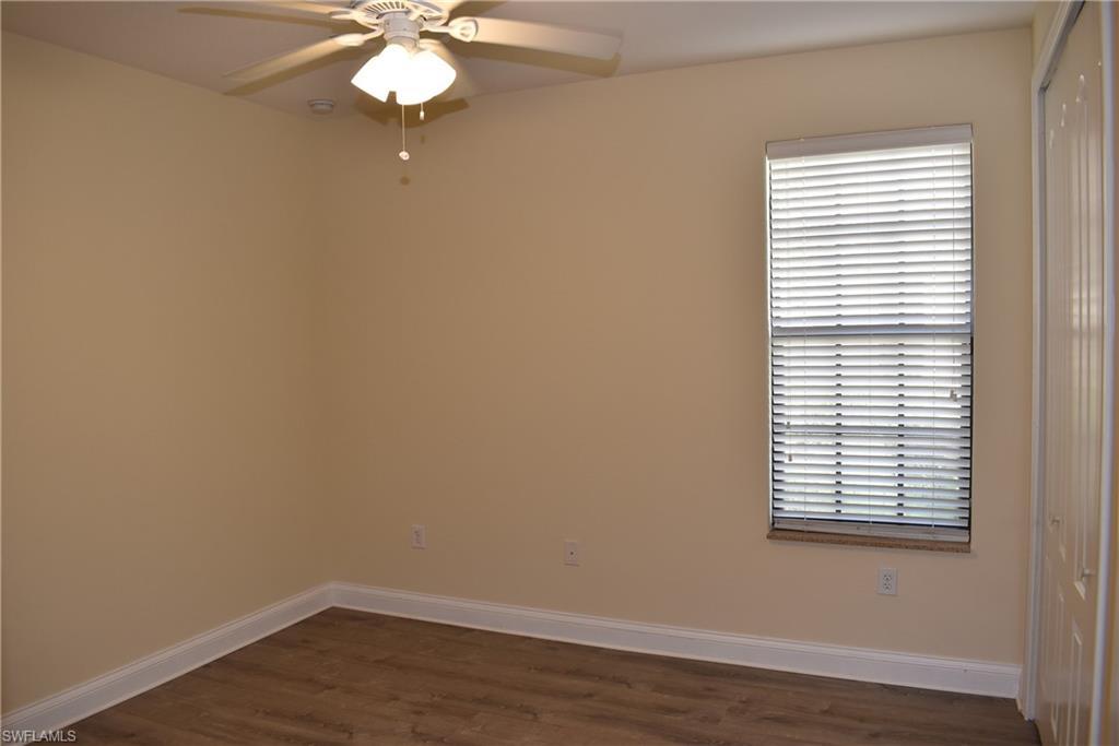 1311 Corso Palermo Court, Unit 2 Naples, FL 34105 - Photo 12 of 15 wooden floor in an empty room with a window