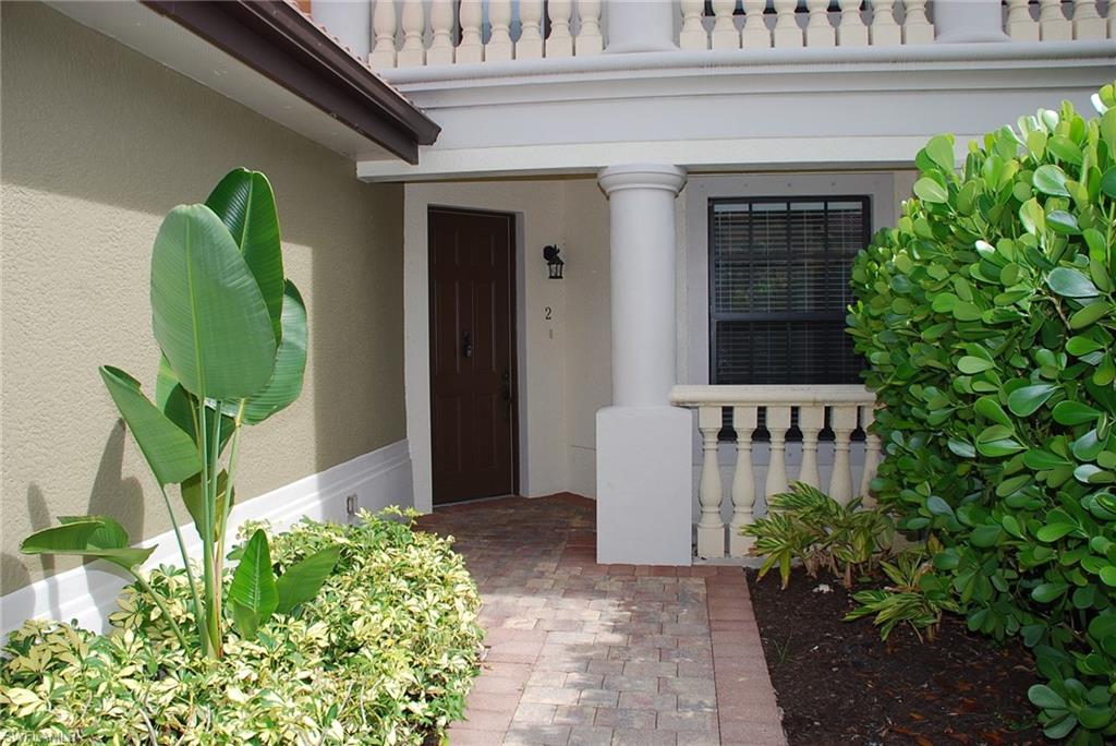 1311 Corso Palermo Court, Unit 2 Naples, FL 34105 - Photo 14 of 15 a front view of a house with a garden