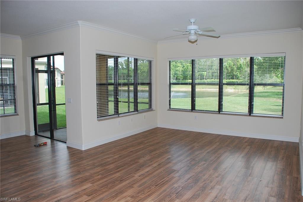 1311 Corso Palermo Court, Unit 2 Naples, FL 34105 - Photo 2 of 15 a view of an empty room with wooden floor and a window