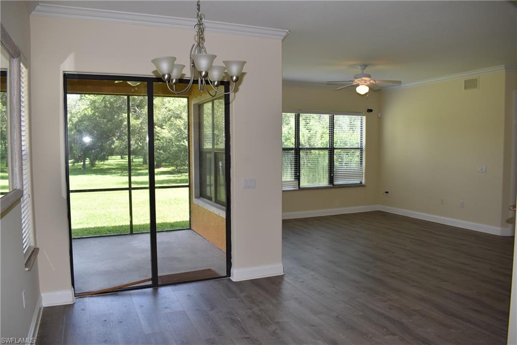 1311 Corso Palermo Court, Unit 2 Naples, FL 34105 - Photo 3 of 15 a view of an empty room with wooden floor and a window