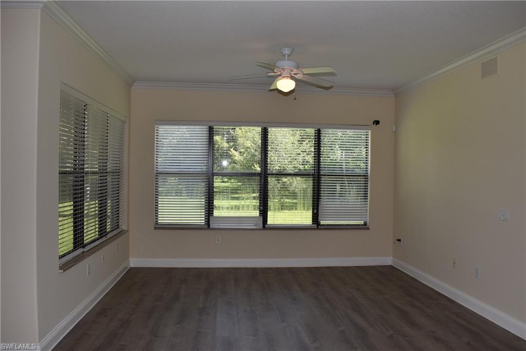 1311 Corso Palermo Court, Unit 2 Naples, FL 34105 - Photo 5 of 15 a view of an empty room with a window and wooden floor