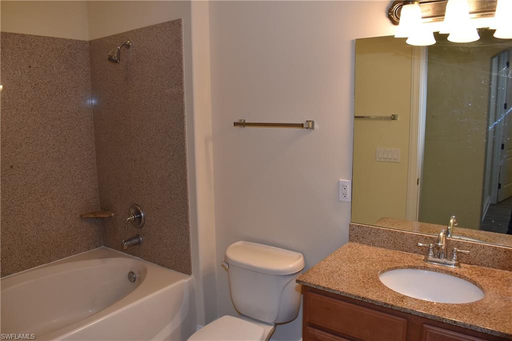 1311 Corso Palermo Court, Unit 2 Naples, FL 34105 - Photo 9 of 15 a bathroom with a sink a toilet and shower