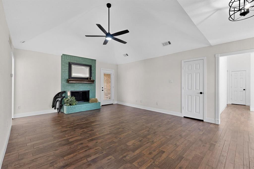 2601 Daisy Lane Rowlett, TX 75089 - Photo 7 of 36 a view of empty room with fireplace and wooden floor