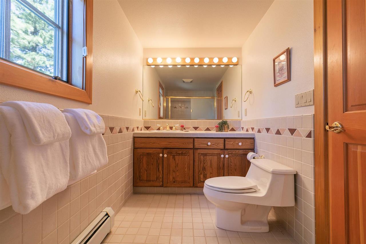 1722 Grouse Ridge Road Truckee, CA 96161 - Photo 16 of 21 a bathroom with a sink a toilet and mirror
