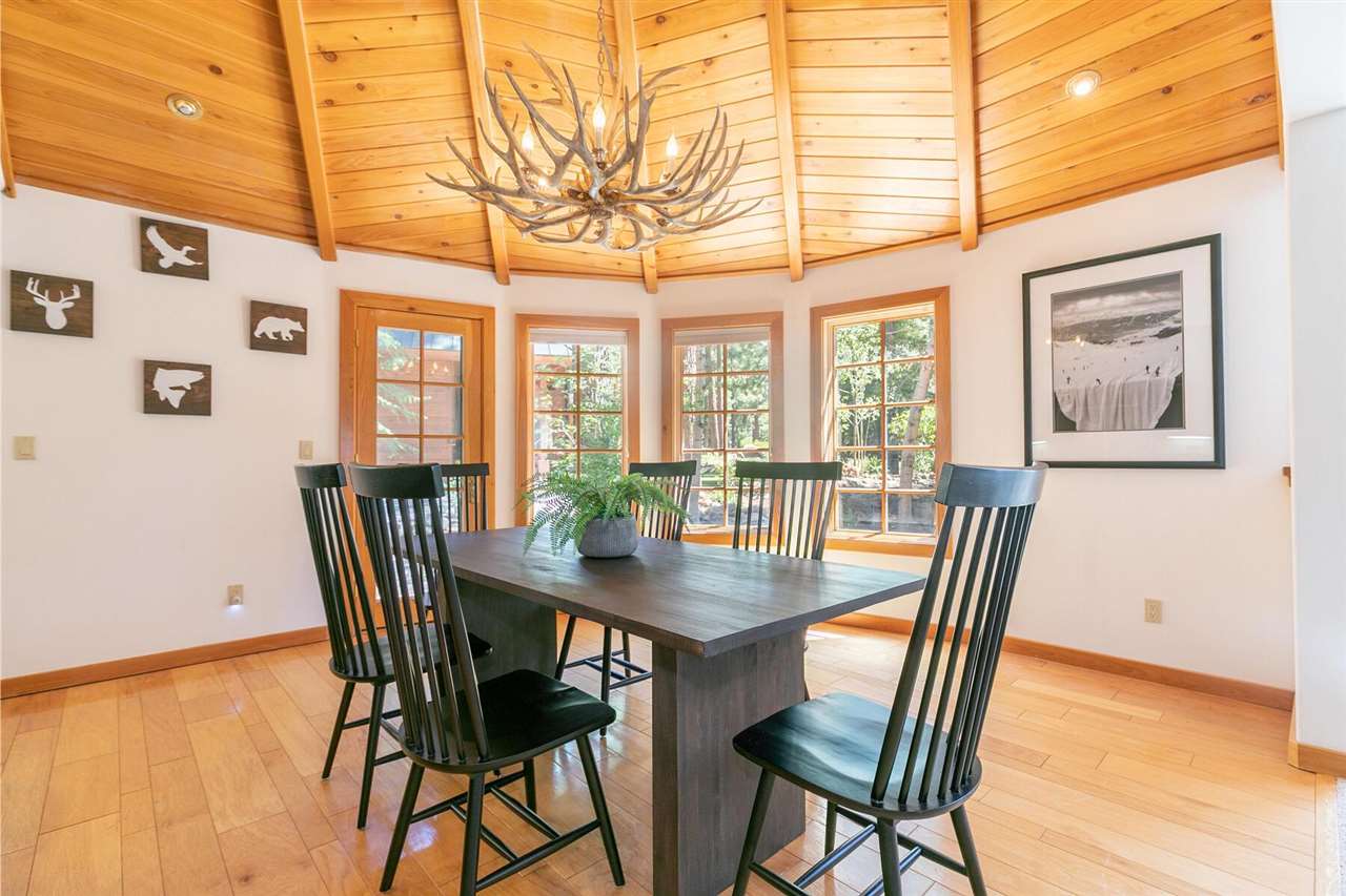 1722 Grouse Ridge Road Truckee, CA 96161 - Photo 4 of 21 a view of a dining room with furniture a chandelier and wooden floor
