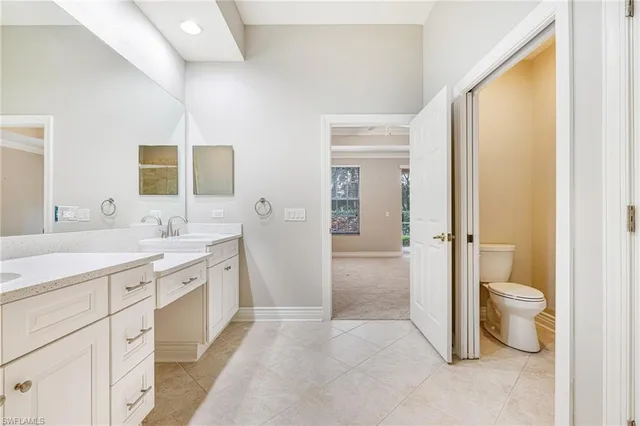 a spacious bathroom with a bathtub sink double and mirror