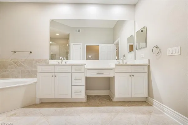 a bedroom with a bed and a mirror
