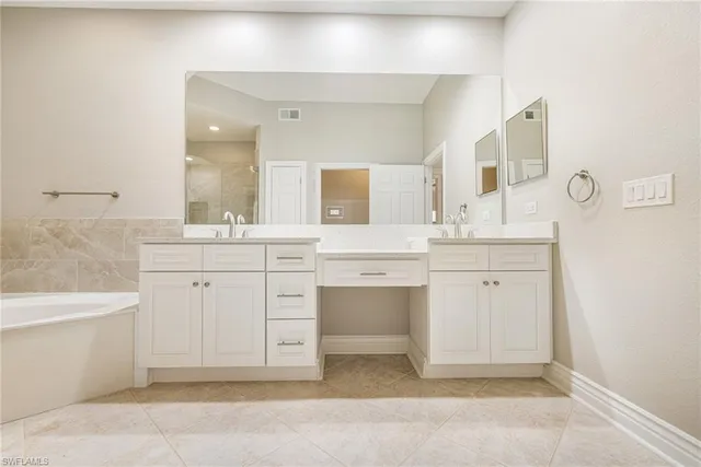 a bedroom with a bed and a mirror