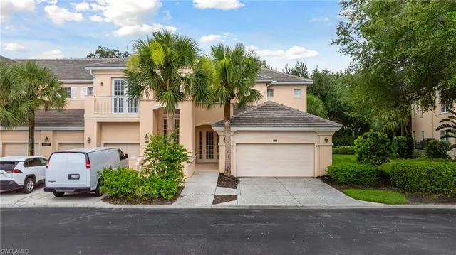 front view of house with a yard and potted plants