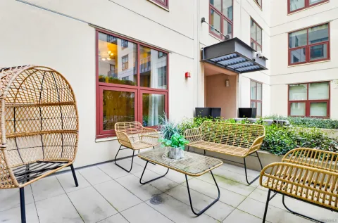 a view of a house with backyard and sitting area