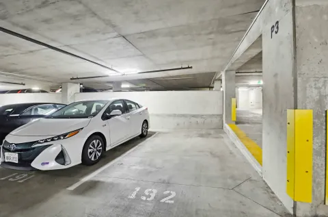 a view of parking garage with cars parked
