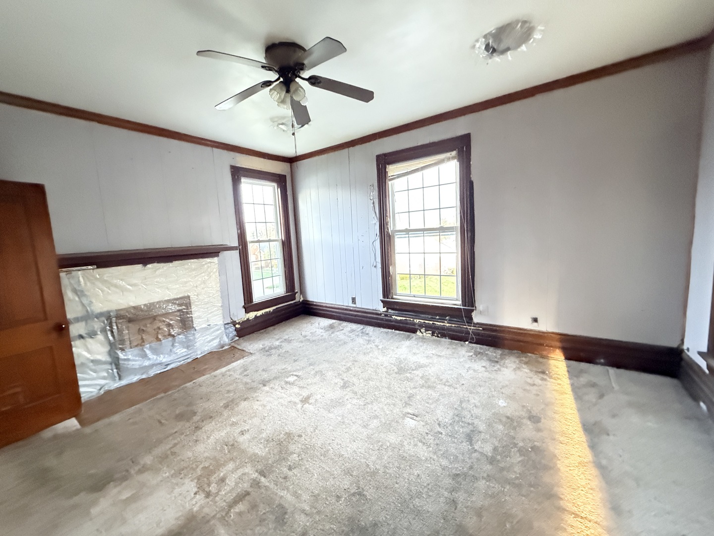 101 5th Street Carmi, IL 62821 - Photo 13 of 28 a view of an empty room with a fireplace and a window