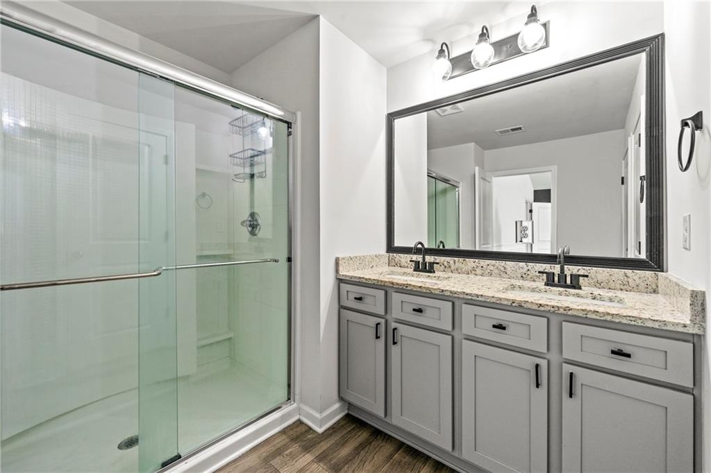 7492 Knoll Hollow Road Lithonia, GA 30058 - Photo 20 of 30 a bathroom with a double vanity sink mirror and shower