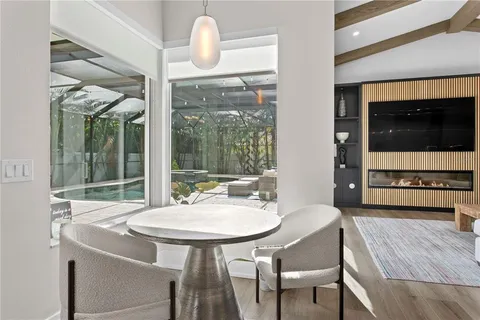 a dining room with furniture and wooden floor