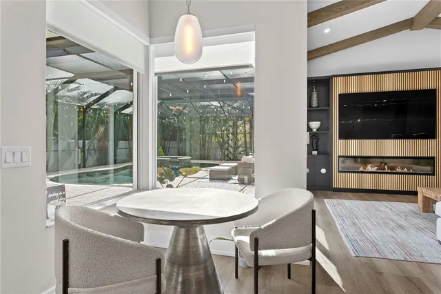 a dining room with furniture and wooden floor