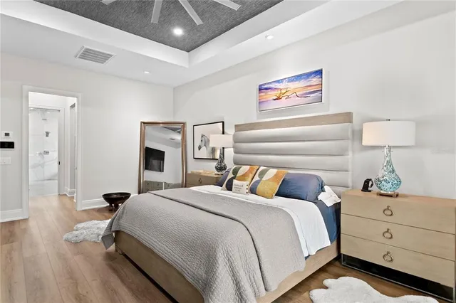 a bedroom with a bed and a lamp on table